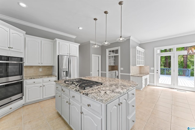 2074 Royal Fern Ln, Hoover, AL 35244 - kitchen featuring white cabinets, appliances with stainless steel finishes, light tile patterned floors, backsplash, and ornamental molding