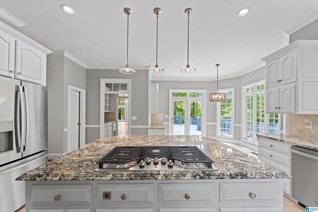 2074 Royal Fern Ln, Hoover, AL 35244 - kitchen with white cabinets, light stone countertops, appliances with stainless steel finishes, and ornamental molding