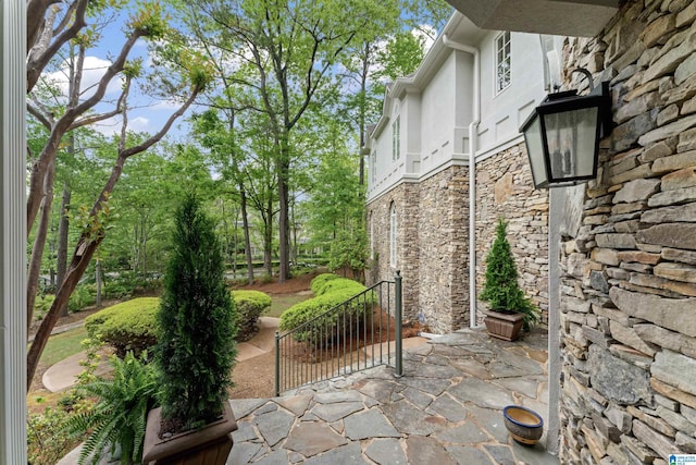 2074 Royal Fern Ln, Hoover, AL 35244 - exterior space with a patio area, stone siding, and stucco siding