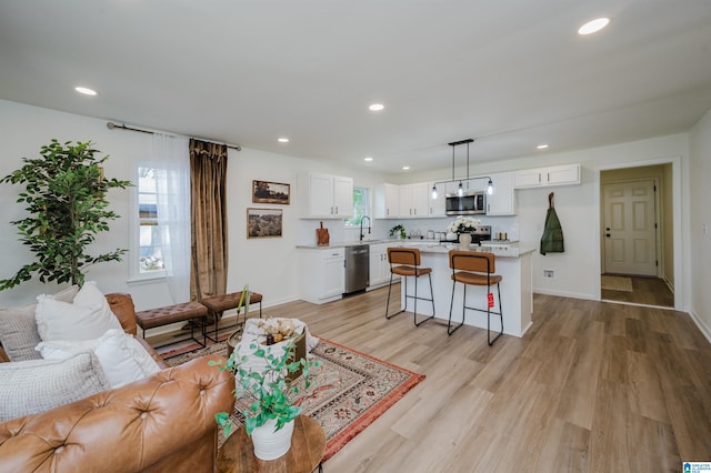 209 Nabors Ave, Hueytown, AL 35023 - living room with recessed lighting, a healthy amount of sunlight, and light wood-style flooring
