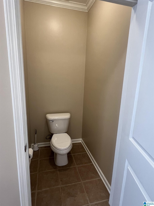 bathroom with baseboards, tile patterned flooring, and toilet