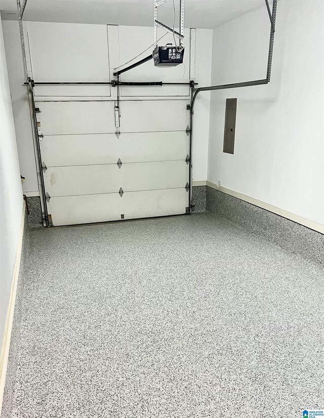 garage with a garage door opener and electric panel