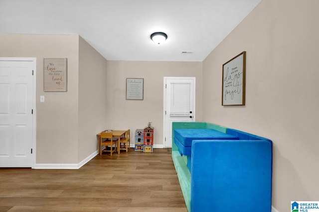 interior space featuring baseboards, wood finished floors, and visible vents