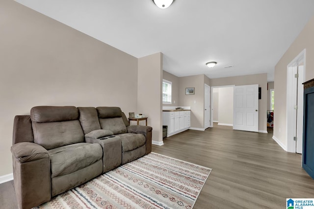 living area featuring baseboards and wood finished floors