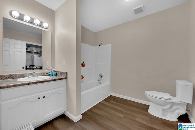 full bath featuring vanity, baseboards, toilet, and wood finished floors
