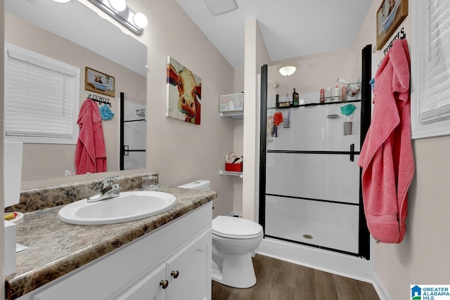 bathroom featuring visible vents, a shower stall, wood finished floors, vanity, and toilet