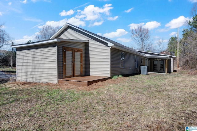 exterior space featuring a yard and central AC