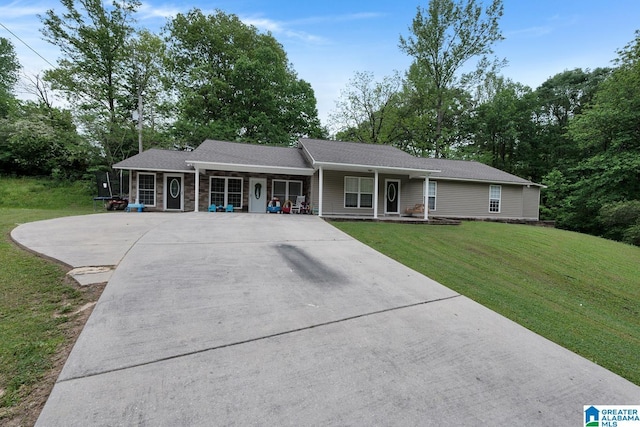 single story home with covered porch, driveway, and a front yard