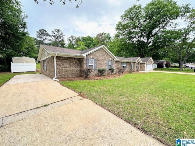 ranch-style house with brick siding, driveway, a front yard, and a garage