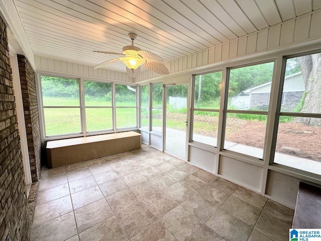 unfurnished sunroom with ceiling fan