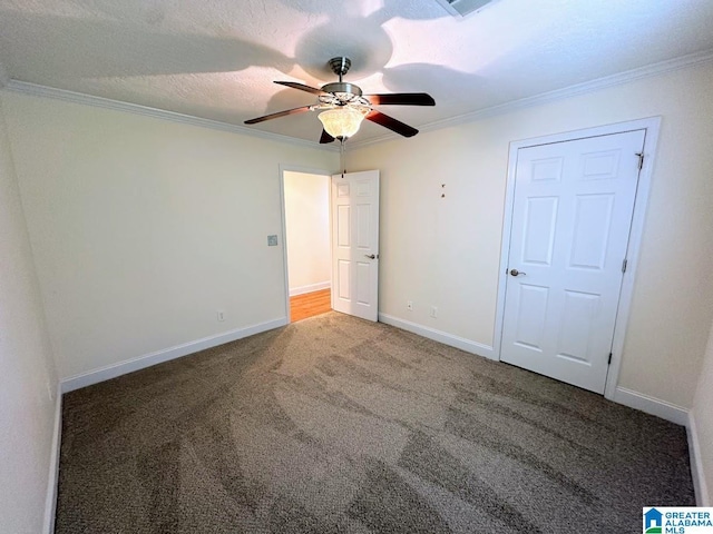 unfurnished bedroom featuring crown molding, carpet floors, baseboards, and ceiling fan