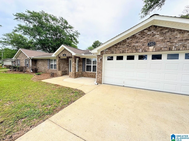 ranch-style home with concrete driveway, brick siding, an attached garage, and a front lawn