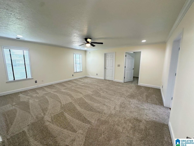 empty room featuring baseboards, ceiling fan, carpet, and ornamental molding