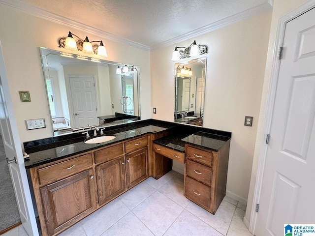 bathroom with tile patterned flooring, ornamental molding, a textured ceiling, and vanity