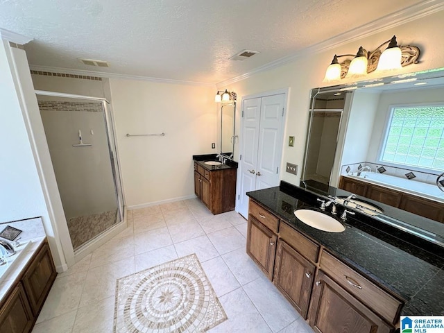 bathroom featuring a sink, a textured ceiling, a stall shower, and ornamental molding