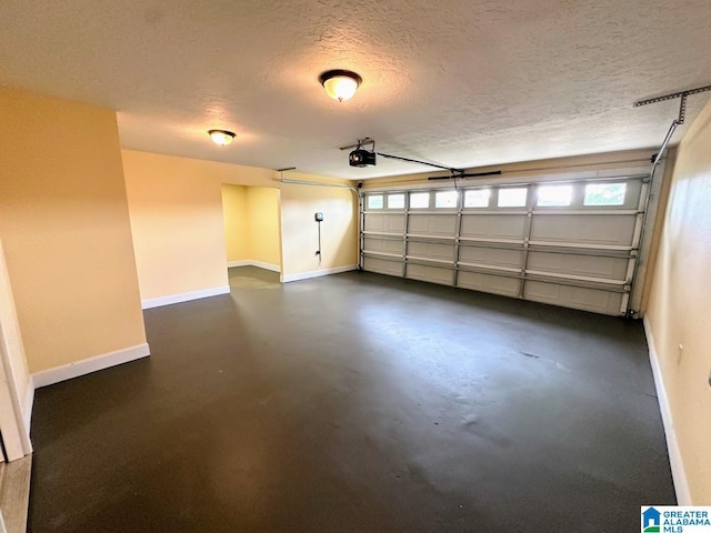 garage with baseboards and a garage door opener