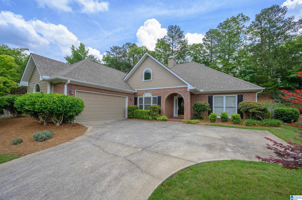 5134 English Turn, Hoover, AL 35242 - view of front of home featuring brick siding, a garage, concrete driveway, and a shingled roof