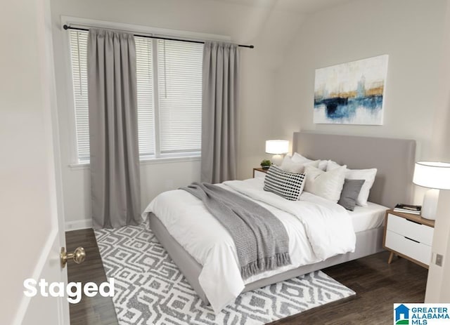 bedroom featuring vaulted ceiling and wood finished floors