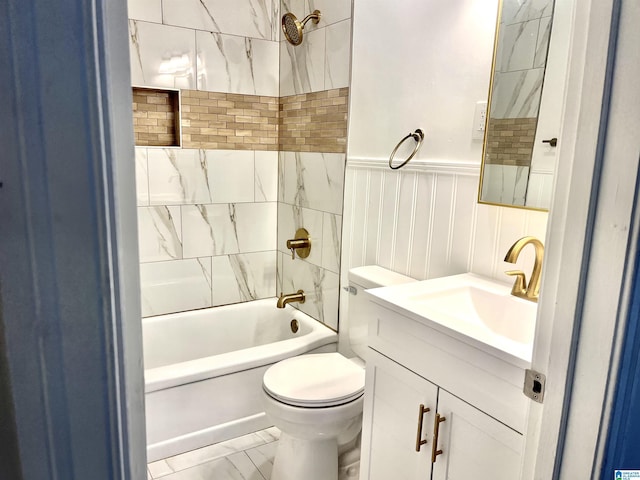 bathroom with wainscoting, vanity, toilet, marble finish floor, and shower / bathtub combination
