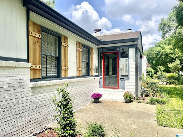 entrance to property featuring brick siding