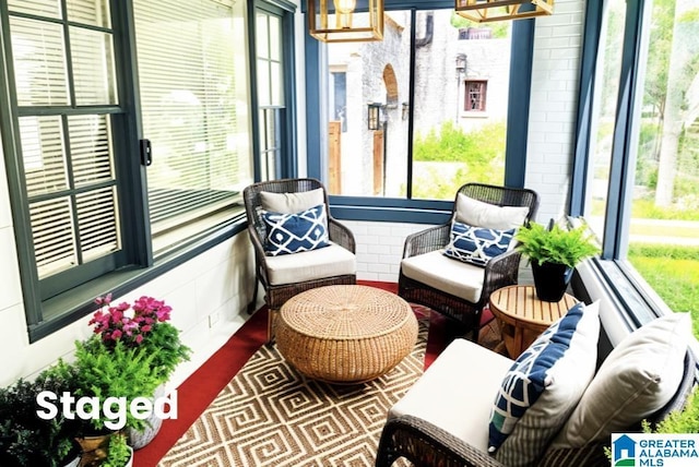 sunroom / solarium with an inviting chandelier