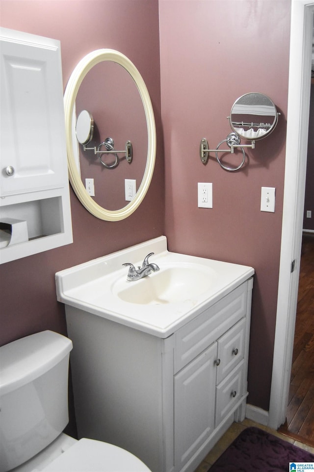 bathroom featuring vanity and toilet