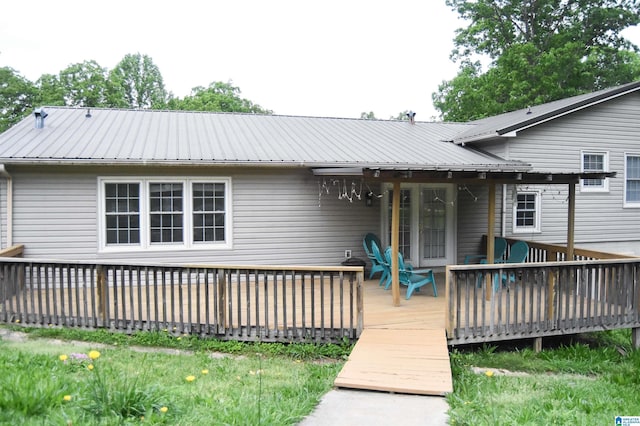 rear view of property featuring a deck and metal roof