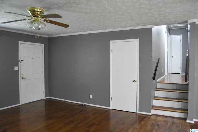 interior space with stairs, a ceiling fan, baseboards, wood finished floors, and ornamental molding