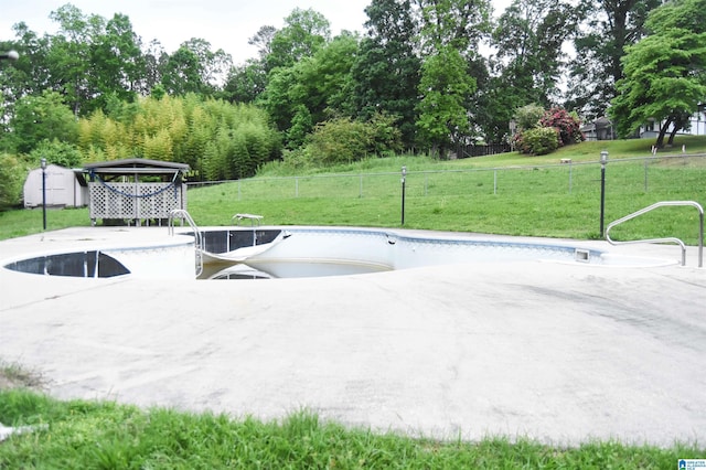 view of patio with a storage shed, fence, an outbuilding, and a fenced in pool