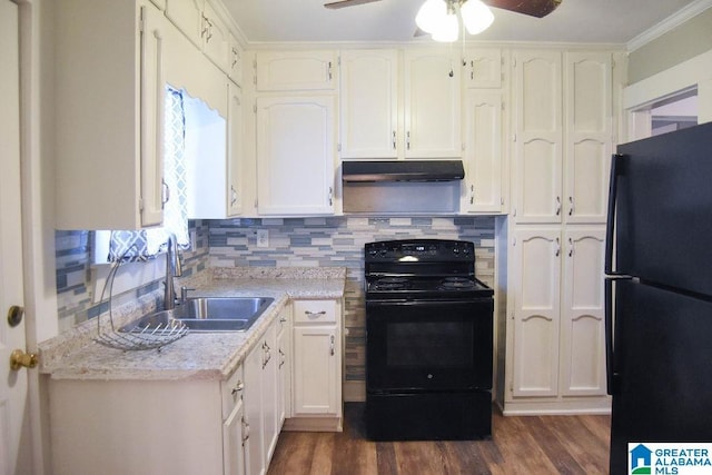 kitchen featuring under cabinet range hood, dark wood finished floors, a sink, and black appliances