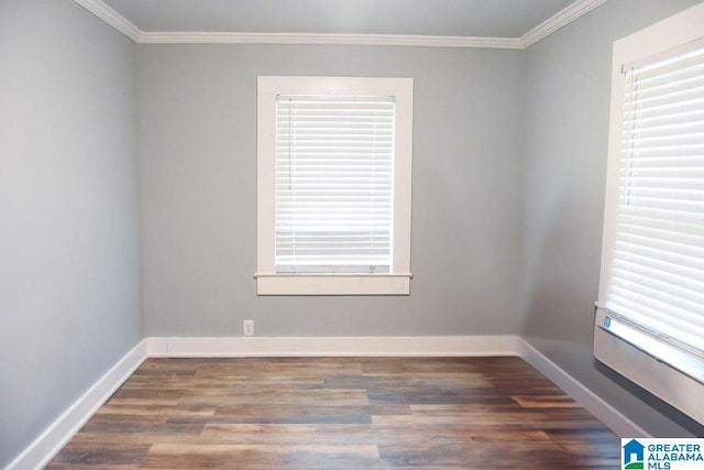 empty room with baseboards, ornamental molding, and wood finished floors