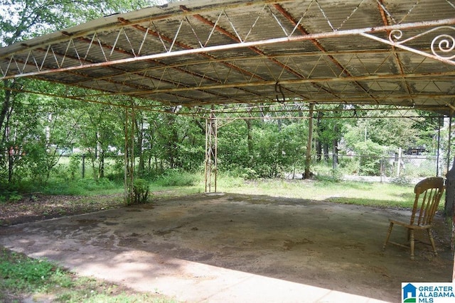 view of vehicle parking featuring fence