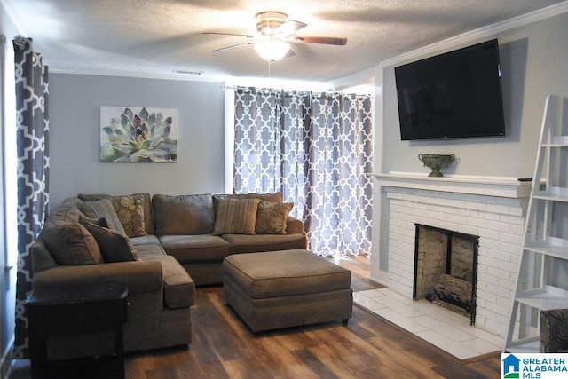 living room with crown molding, a ceiling fan, wood finished floors, and a fireplace