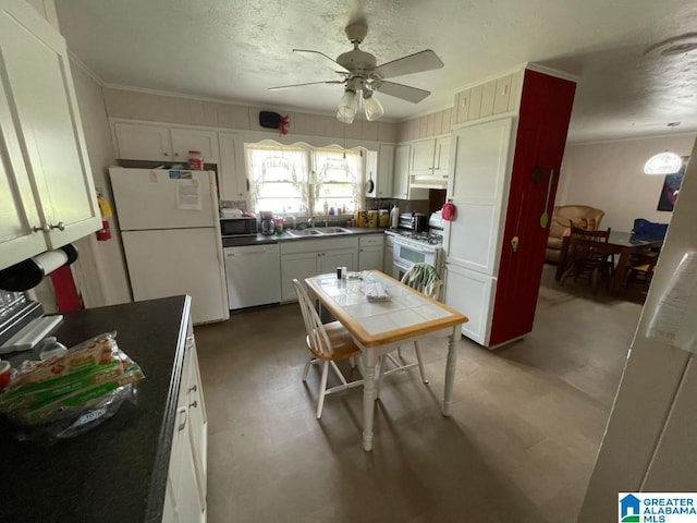 kitchen featuring white cabinets, ceiling fan, a sink, white appliances, and tile countertops