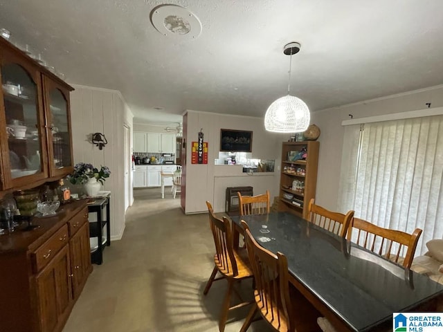 dining area featuring light colored carpet and a notable chandelier