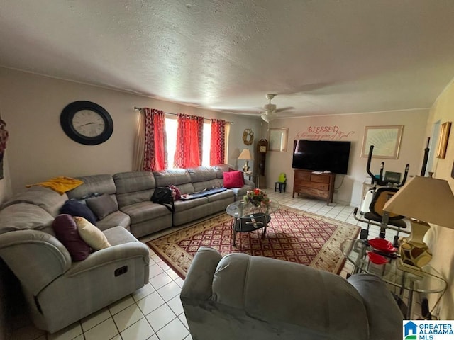 living room with light tile patterned floors, ceiling fan, and a textured ceiling