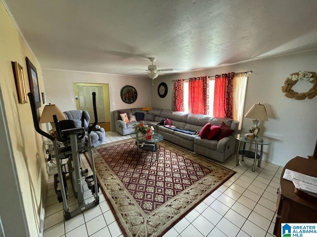living area featuring light tile patterned floors, a ceiling fan, and a textured ceiling