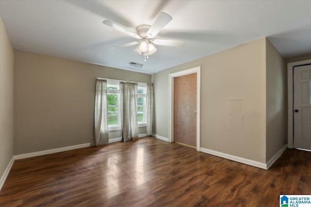 unfurnished bedroom with baseboards, a ceiling fan, wood finished floors, and visible vents