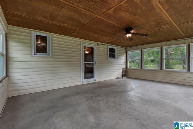 unfurnished sunroom featuring ceiling fan