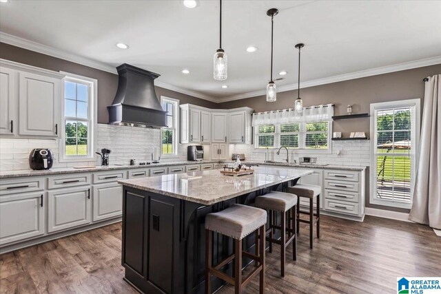 1520 Day Gap Rd, Cullman, AL 35057 - kitchen with custom range hood, decorative backsplash, white cabinetry, and a kitchen island