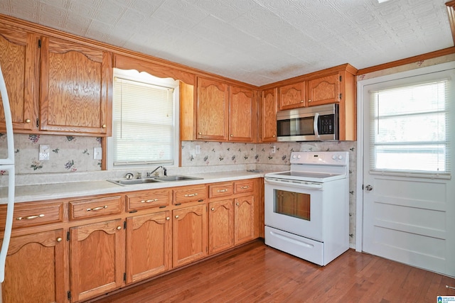2928 University Way, Centreville, AL 35042 - kitchen with wood finished floors, stainless steel microwave, a wealth of natural light, and electric stove