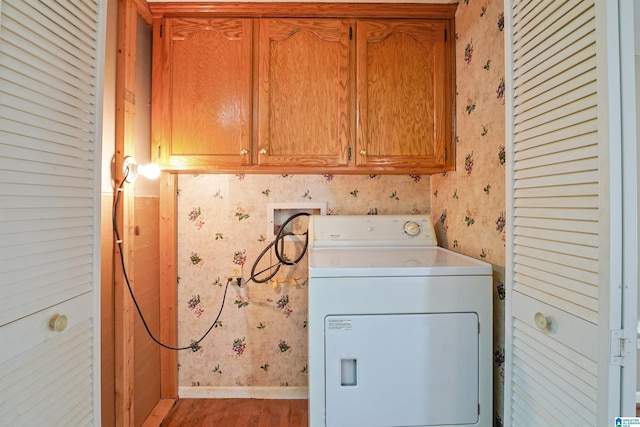 2928 University Way, Centreville, AL 35042 - washroom with washer / dryer, wood finished floors, baseboards, wallpapered walls, and cabinet space