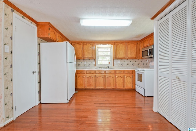 2928 University Way, Centreville, AL 35042 - kitchen with white appliances, a sink, light wood finished floors, and light countertops