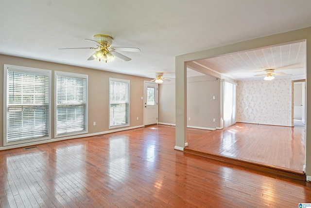 2928 University Way, Centreville, AL 35042 - unfurnished living room with baseboards, ceiling fan, and hardwood / wood-style flooring