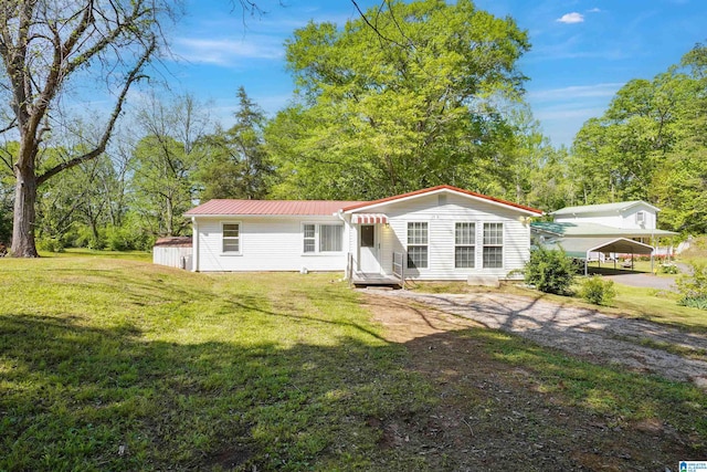 2928 University Way, Centreville, AL 35042 - view of front of house featuring a carport, metal roof, driveway, and a front lawn