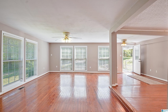 2928 University Way, Centreville, AL 35042 - unfurnished living room featuring wood-type flooring, a ceiling fan, baseboards, and visible vents