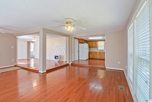 2928 University Way, Centreville, AL 35042 - unfurnished living room with ceiling fan, visible vents, baseboards, light wood finished floors, and heating unit