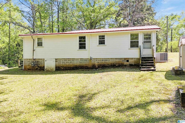 2928 University Way, Centreville, AL 35042 - rear view of house with crawl space, entry steps, central air condition unit, a lawn, and metal roof