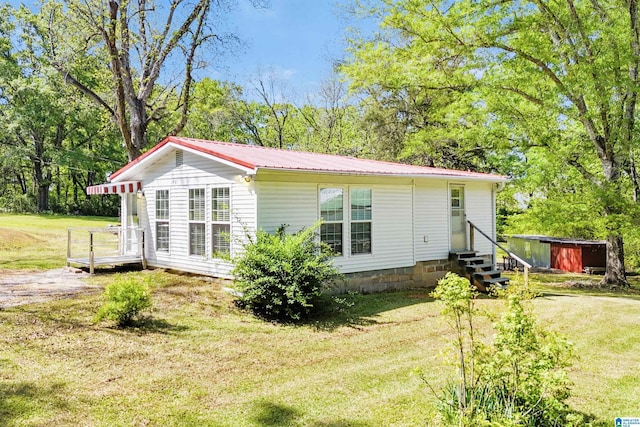 2928 University Way, Centreville, AL 35042 - back of property with entry steps, an outdoor structure, a yard, and metal roof