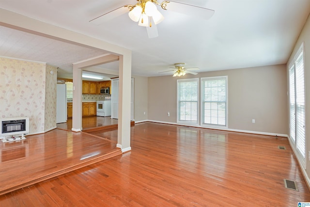 2928 University Way, Centreville, AL 35042 - unfurnished living room featuring light wood-style flooring, a ceiling fan, baseboards, heating unit, and visible vents